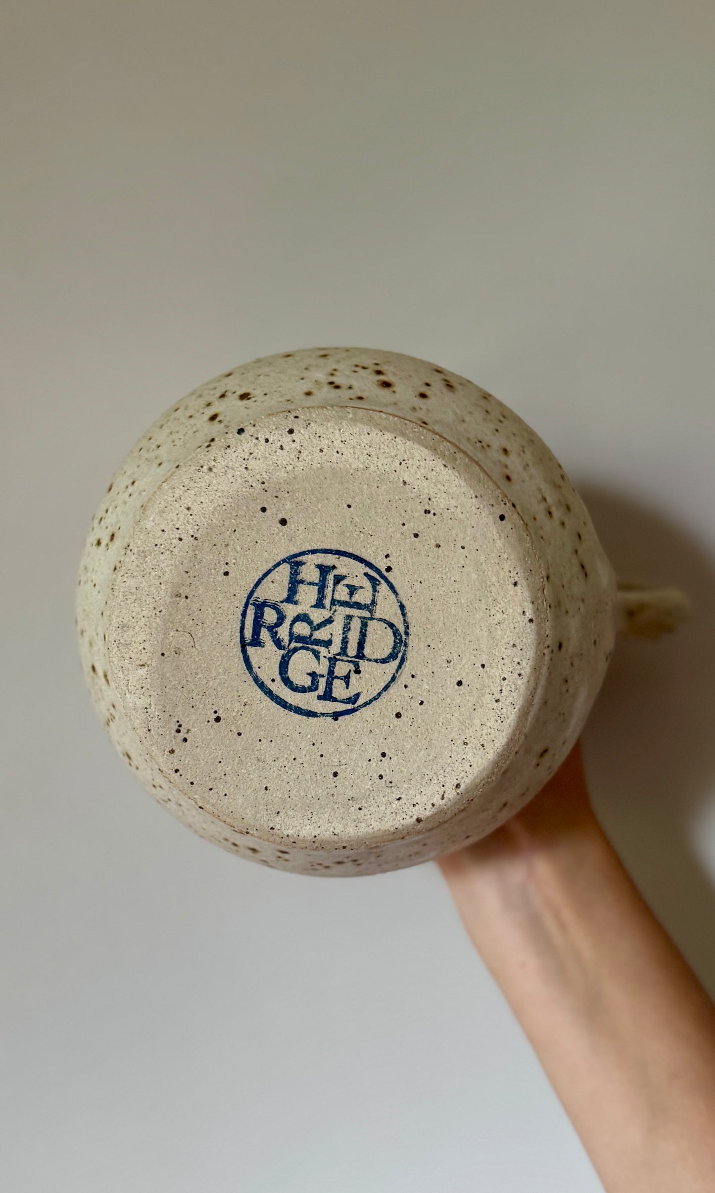 Ceramic jug with speckled texture and 'Herridge' branding on a plain background