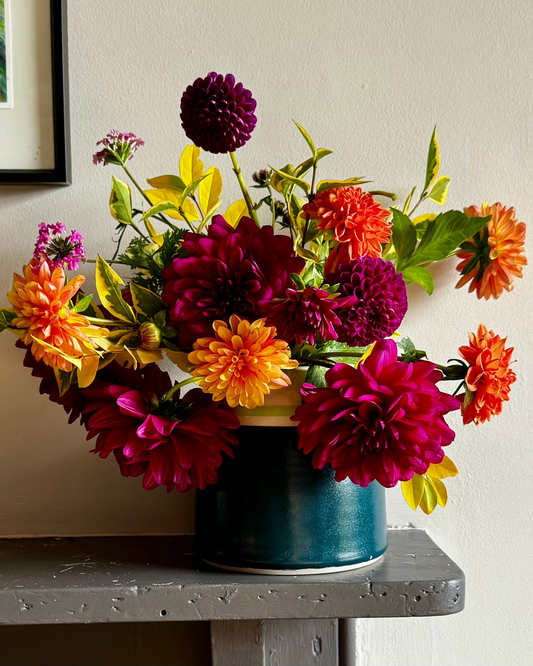 Handmade ceramic vase from Herridge Pottery in Bali blue with lime and detail. Vase contains a bunch of richly coloured dahlias.