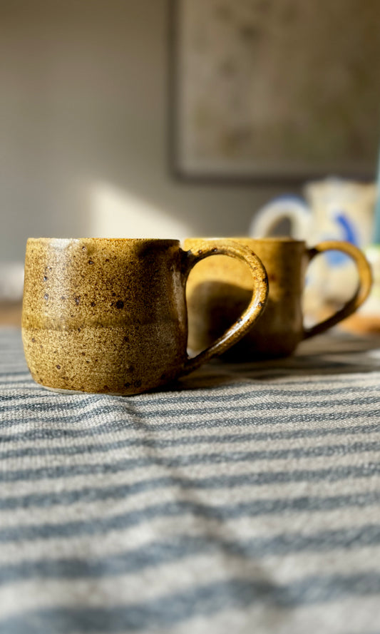 Handmade ceramic amber mug from herridge pottery - on table