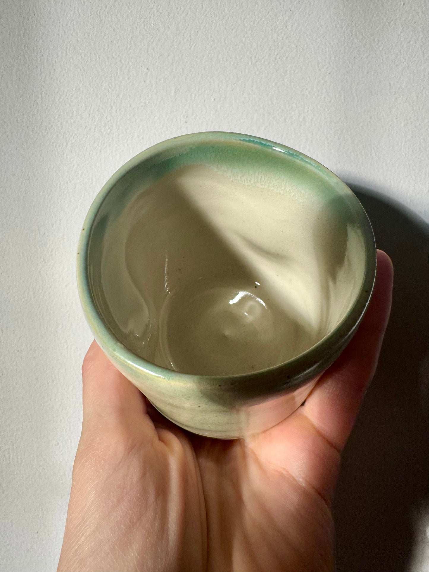 Handmade ceramic dimple coffee cup by Herridge Pottery in Celadon Green.