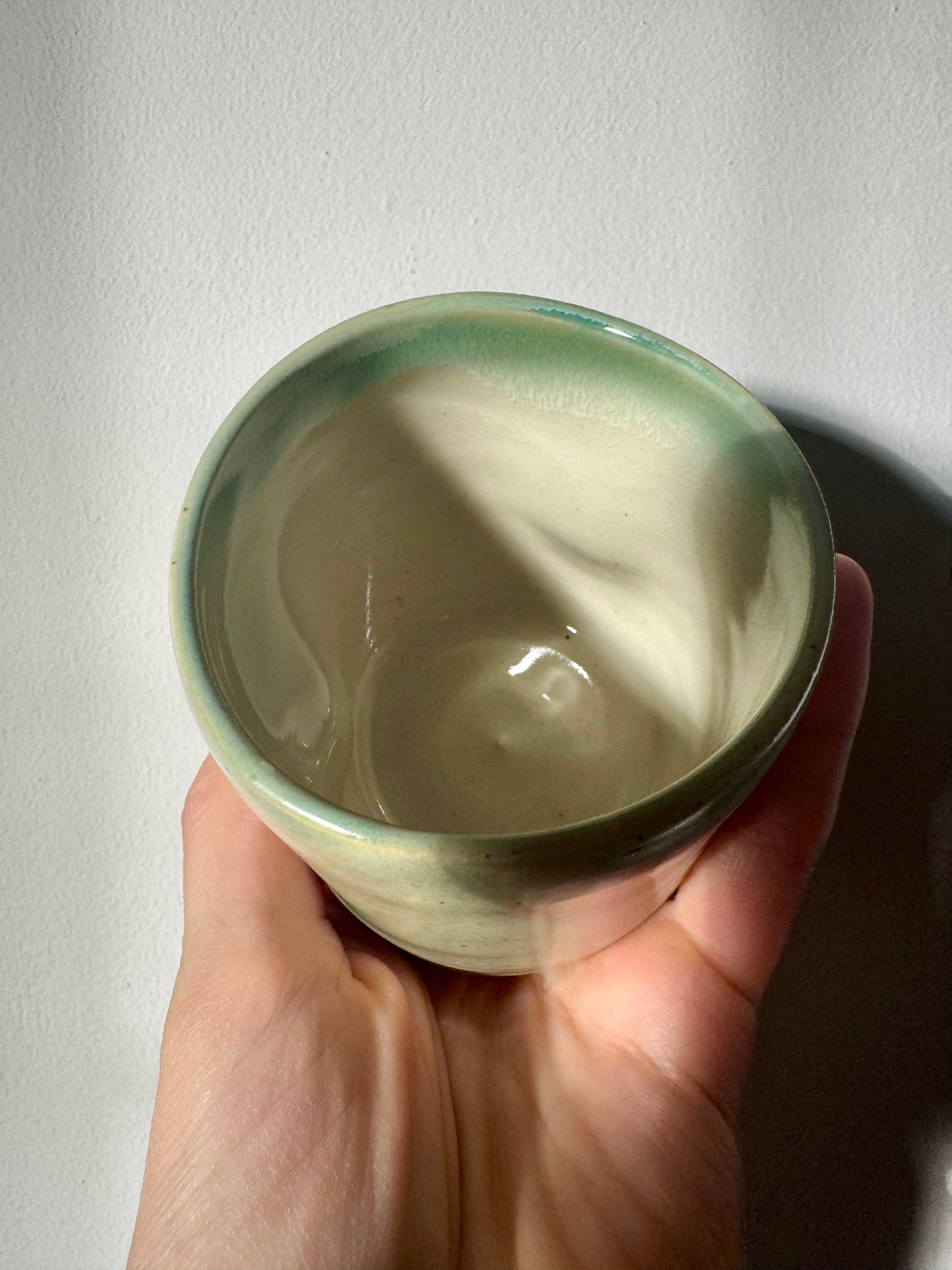 Handmade ceramic dimple coffee cup by Herridge Pottery in Celadon Green.