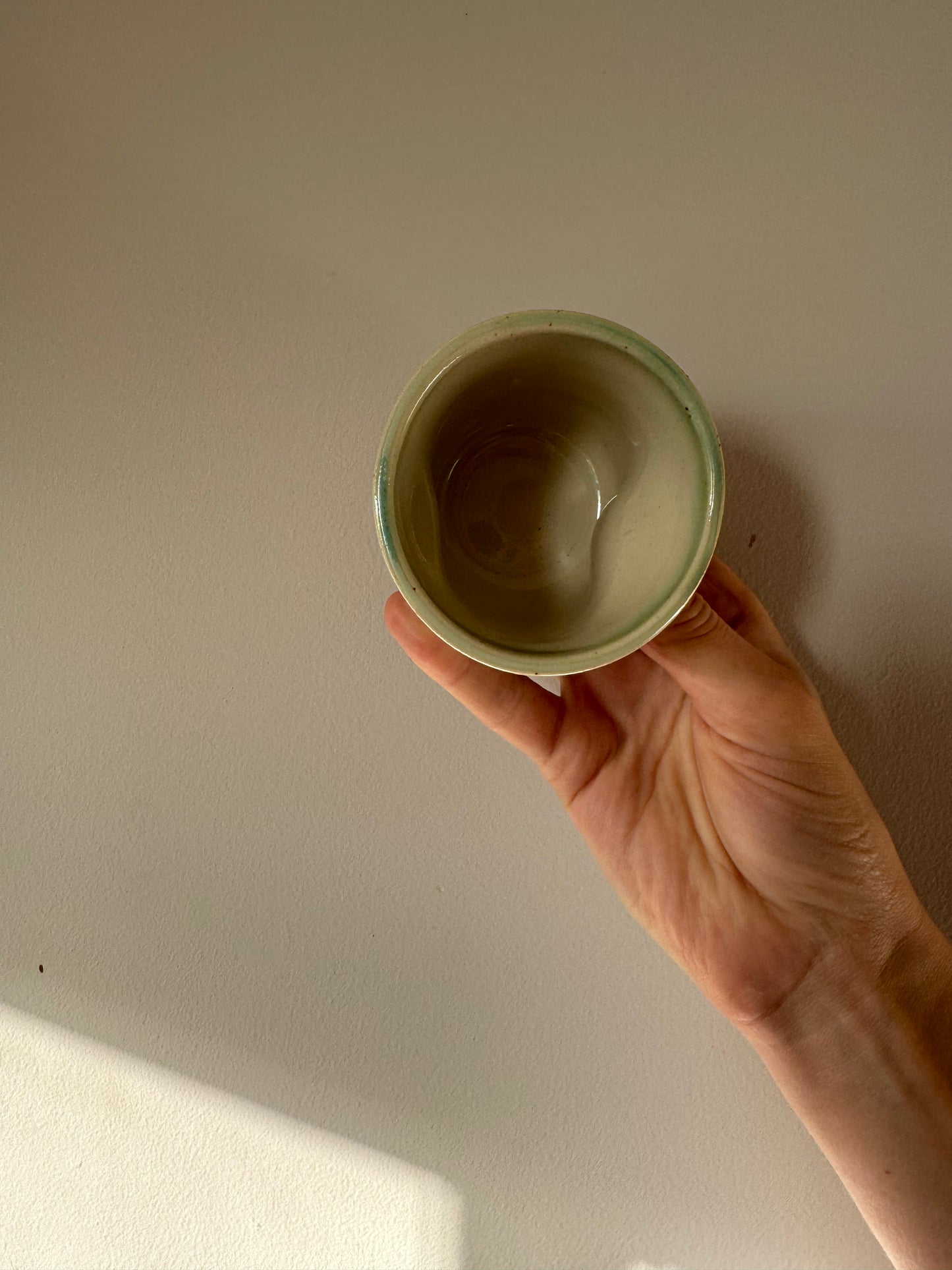 Handmade ceramic dimple coffee cup by Herridge Pottery in Celadon Green.