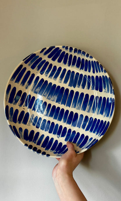 Handmade ceramic extra large feasting bowl with blue splodges by Herridge Pottery - held