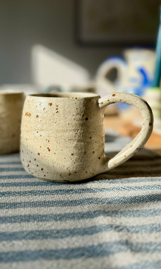 Handmade ceramic oatmeal mug from herridge pottery - on table two