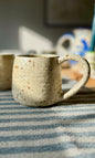 Handmade ceramic oatmeal mug from herridge pottery - on table two