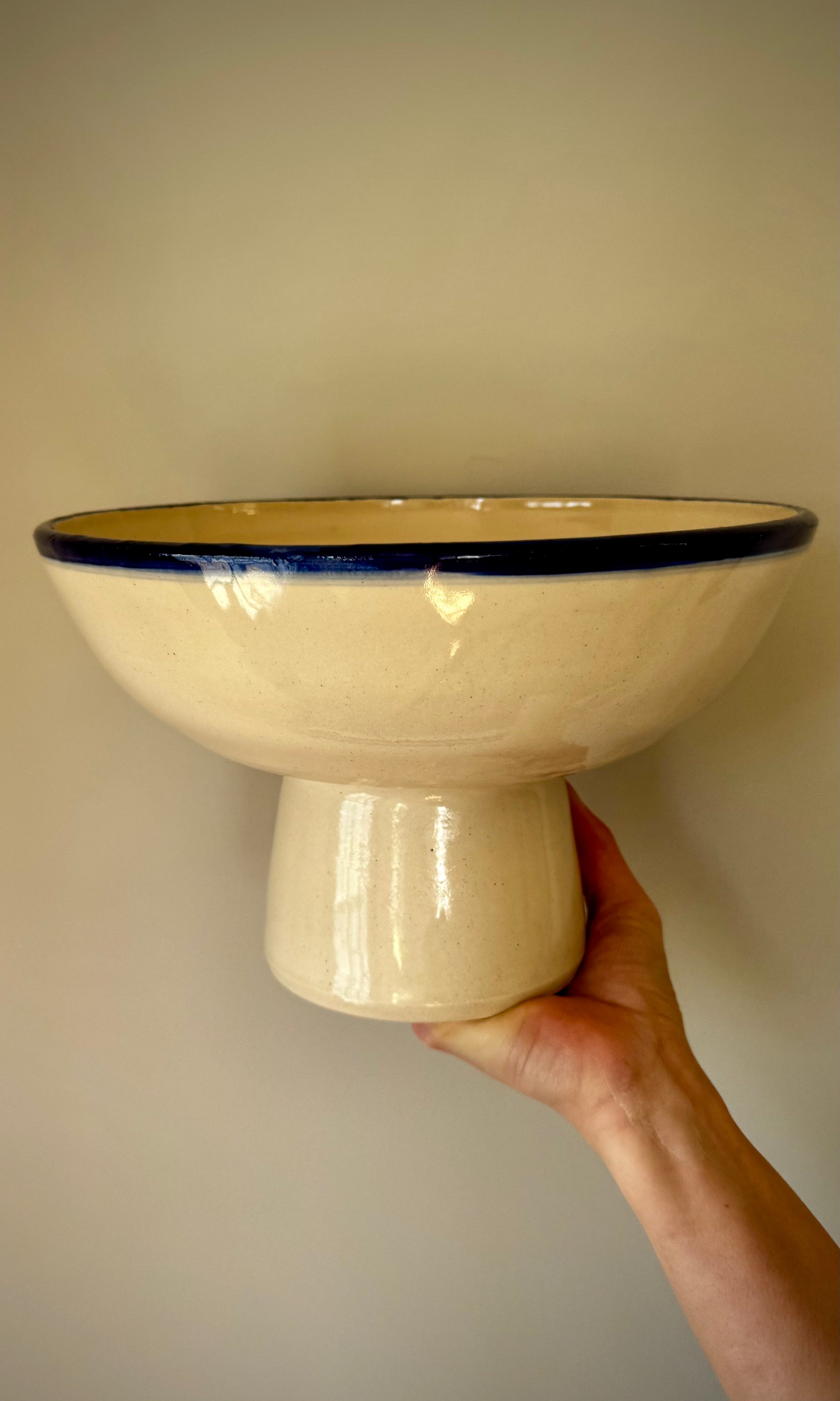 Handmade ceramic pedestal feasting bowl from Herridge Pottery - held