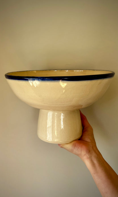 Handmade ceramic pedestal feasting bowl from Herridge Pottery - held