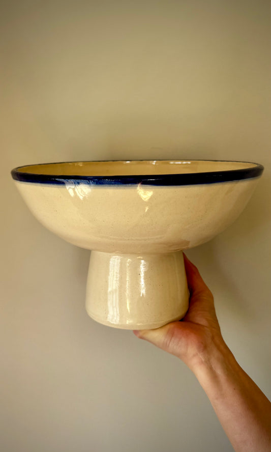 Handmade ceramic pedestal feasting bowl from Herridge Pottery - held