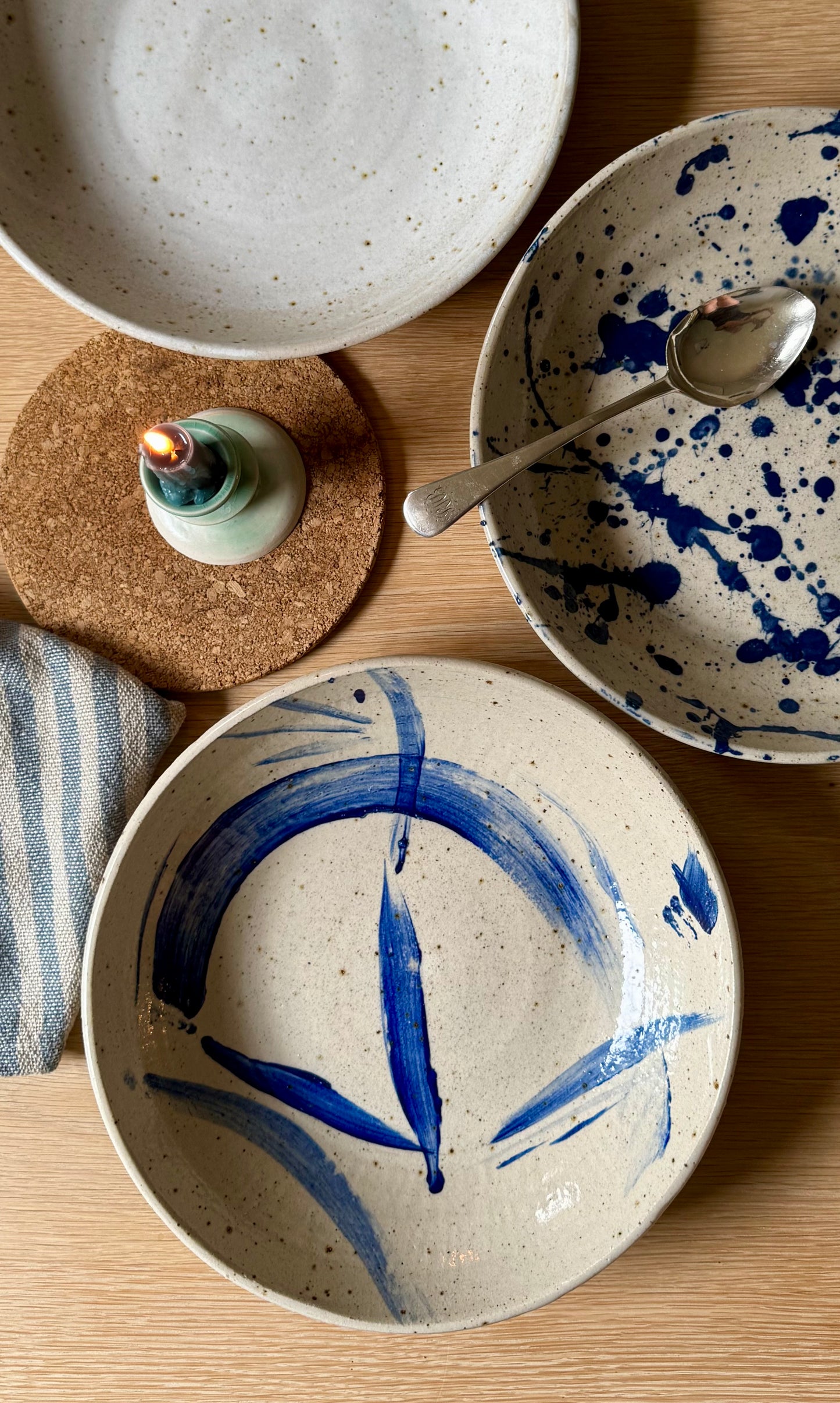 Ceramic bowls with blue abstract designs on a wooden surface.