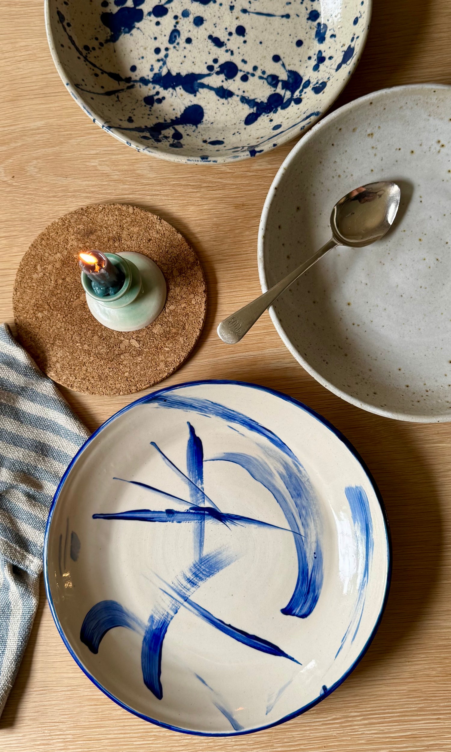 Ceramic plates with blue abstract designs on a wooden table.