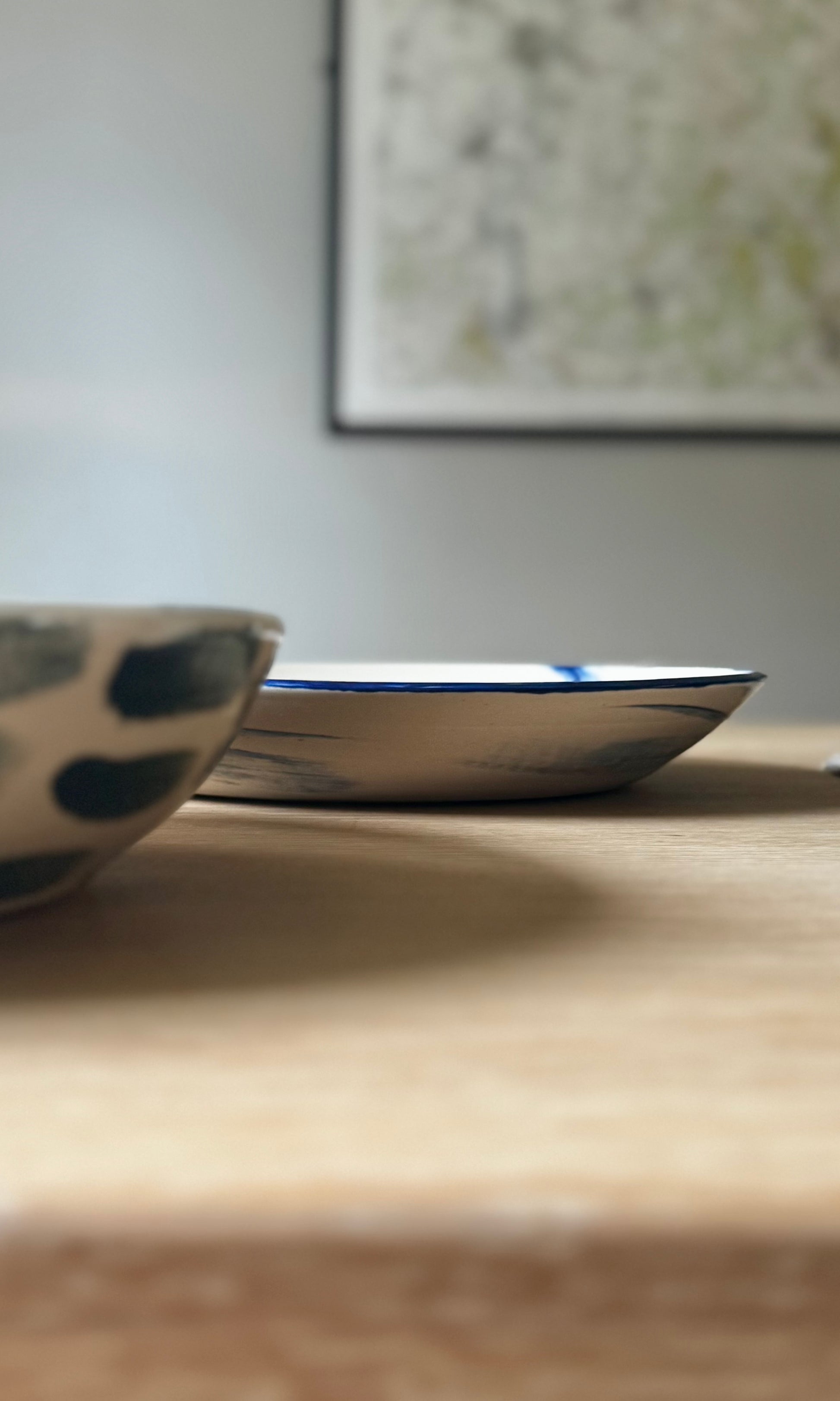 Two ceramic bowls on a wooden surface with a blurred background