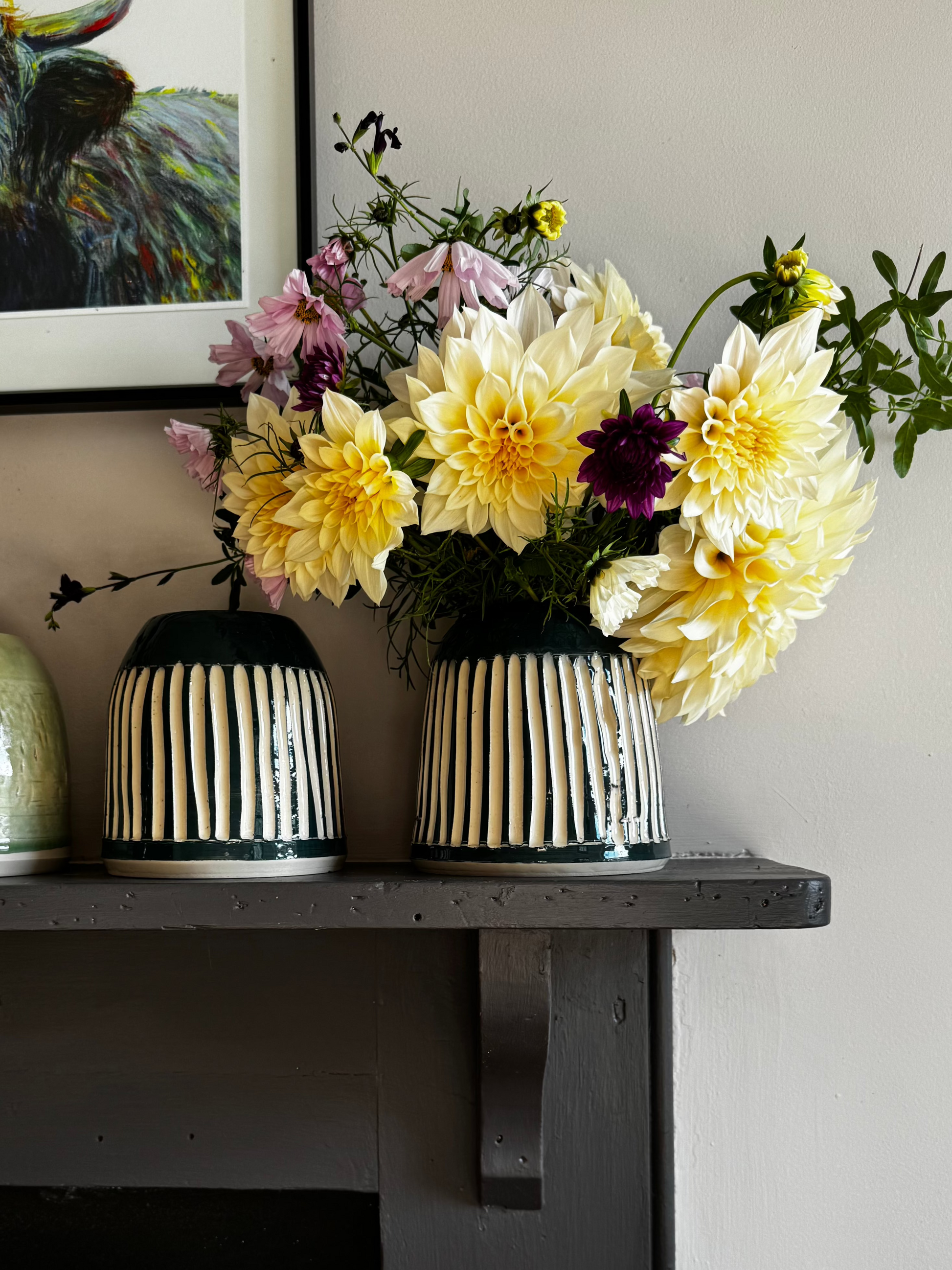 Several Herridge Pottery vases on a shelf.